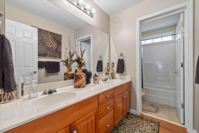 bathroom featuring vanity, tile patterned floors, and toilet