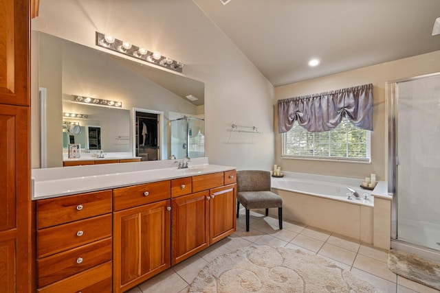 bathroom featuring lofted ceiling, vanity, tile patterned flooring, and shower with separate bathtub