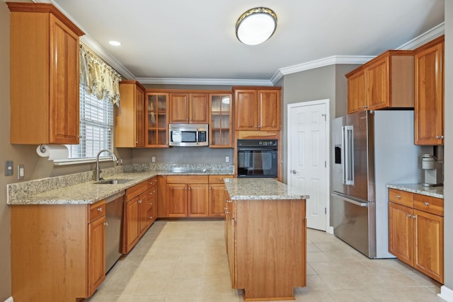 kitchen featuring sink, crown molding, stainless steel appliances, light stone counters, and a kitchen island