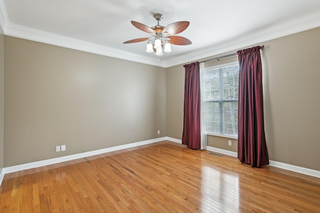 unfurnished room featuring ornamental molding, ceiling fan, and light wood-type flooring