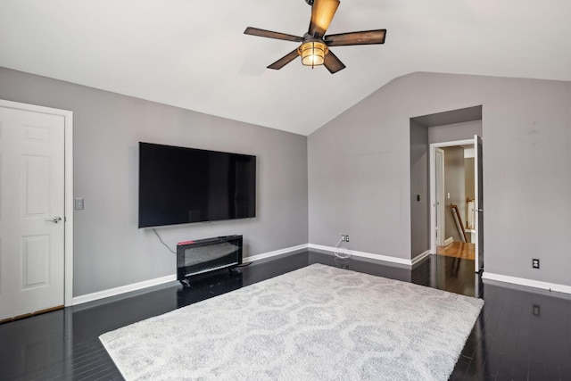 living room featuring vaulted ceiling, dark hardwood / wood-style floors, and ceiling fan