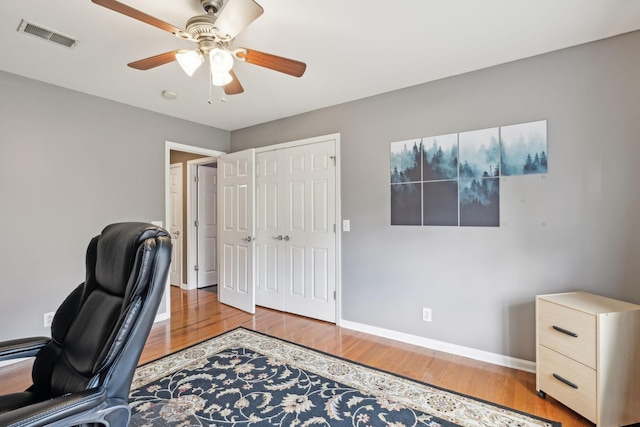 office space with ceiling fan and light wood-type flooring