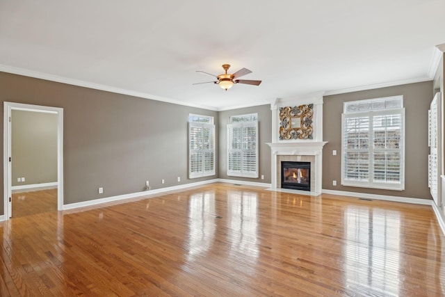 unfurnished living room featuring crown molding, ceiling fan, and light wood-type flooring