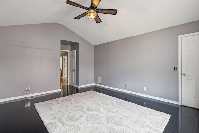 unfurnished bedroom with dark wood-type flooring, vaulted ceiling, and ceiling fan