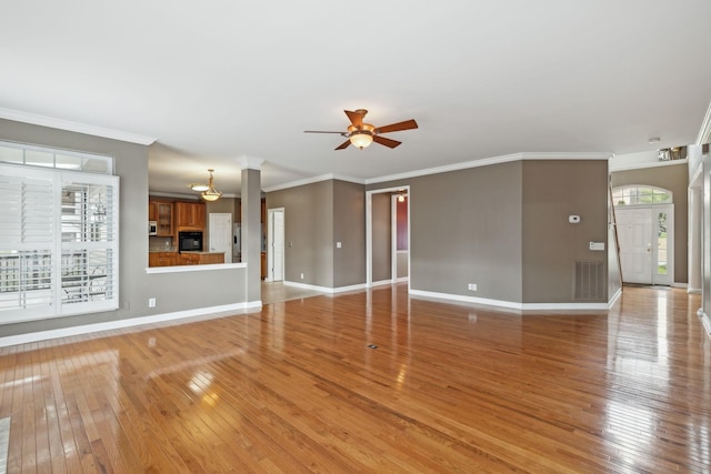 unfurnished living room with ornamental molding, light hardwood / wood-style floors, and ceiling fan