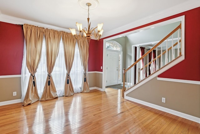 interior space with an inviting chandelier, hardwood / wood-style floors, and a wealth of natural light