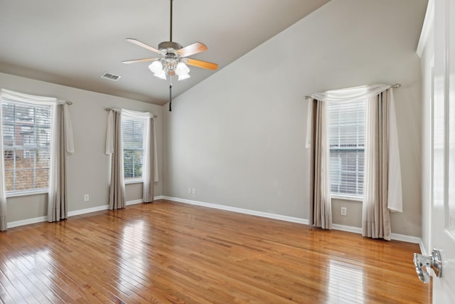 spare room with vaulted ceiling, ceiling fan, and light hardwood / wood-style flooring