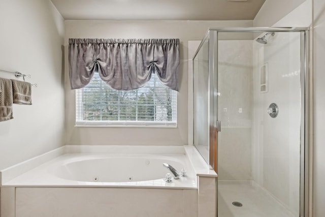 bathroom featuring shower with separate bathtub