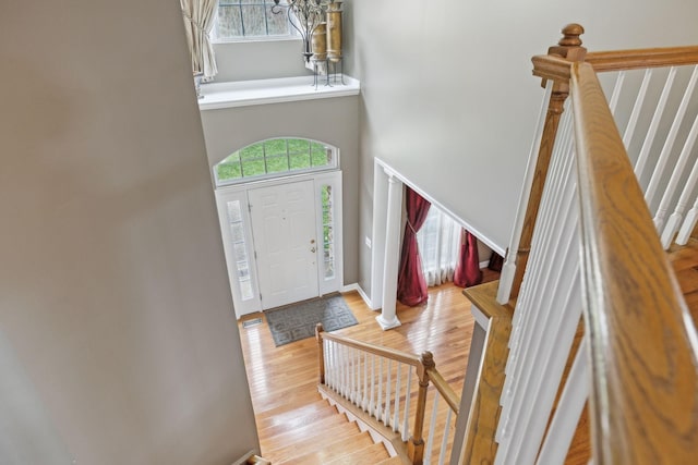 foyer with a towering ceiling and light hardwood / wood-style floors