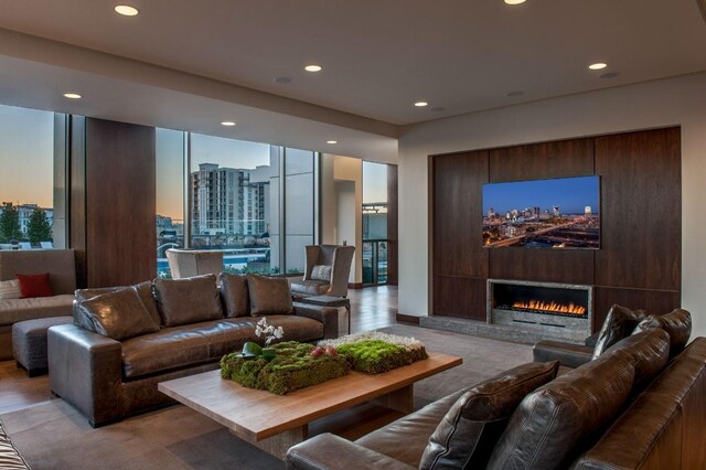 living room featuring light wood-type flooring and a large fireplace