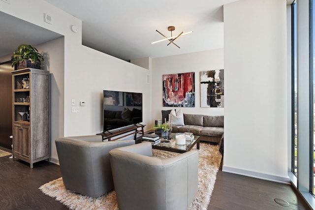 living room featuring dark hardwood / wood-style flooring and a notable chandelier