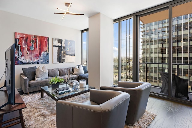 living room featuring wood-type flooring and a wall of windows