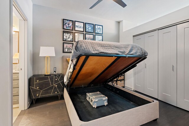 bedroom with ensuite bath, dark hardwood / wood-style floors, ceiling fan, and a closet