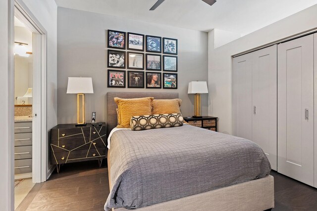 bedroom featuring a closet, ensuite bath, ceiling fan, and dark hardwood / wood-style floors