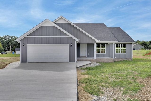 view of front of house with a porch, a garage, and a front yard