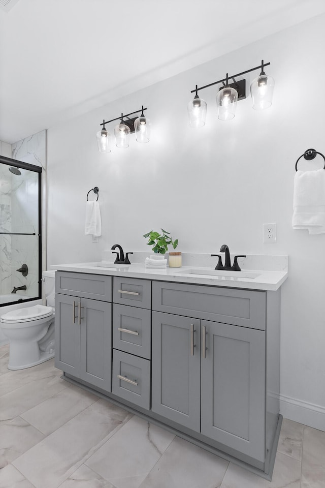 bathroom with tile patterned floors, double sink vanity, and toilet