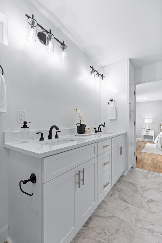 bathroom featuring double sink vanity and wood-type flooring