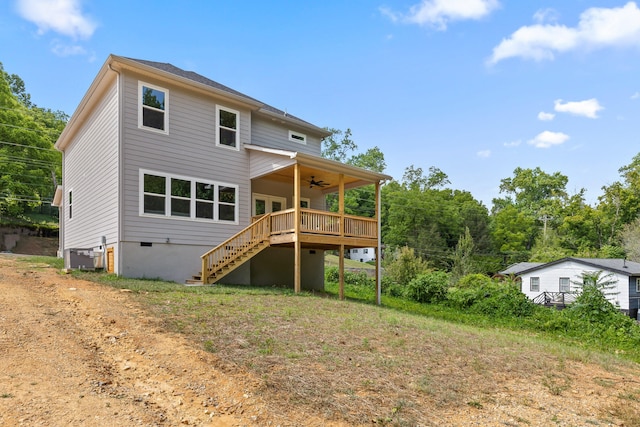 back of property with a wooden deck and ceiling fan