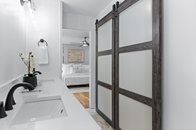 bathroom featuring hardwood / wood-style flooring and ceiling fan