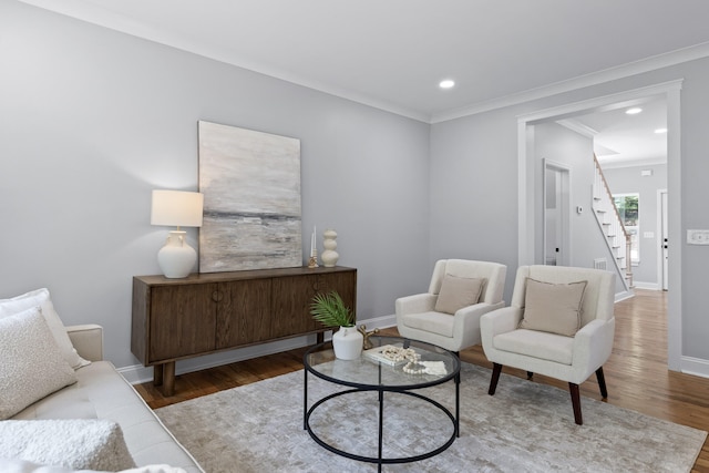 living room with ornamental molding and hardwood / wood-style flooring