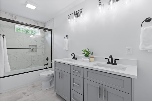 full bathroom with enclosed tub / shower combo, double sink vanity, toilet, and tile patterned flooring