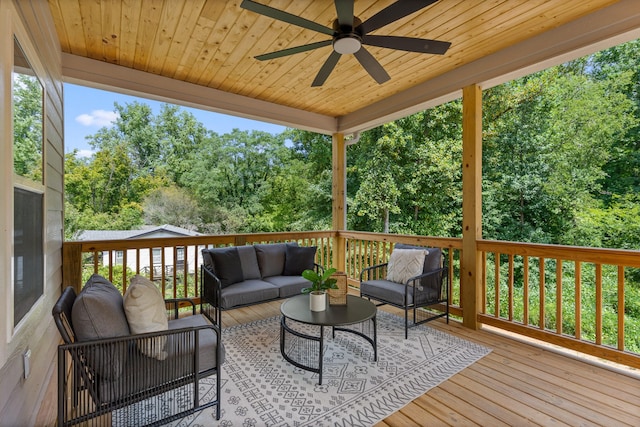 wooden terrace featuring ceiling fan and an outdoor hangout area