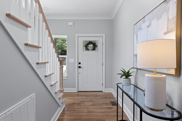 entrance foyer with crown molding and dark hardwood / wood-style flooring