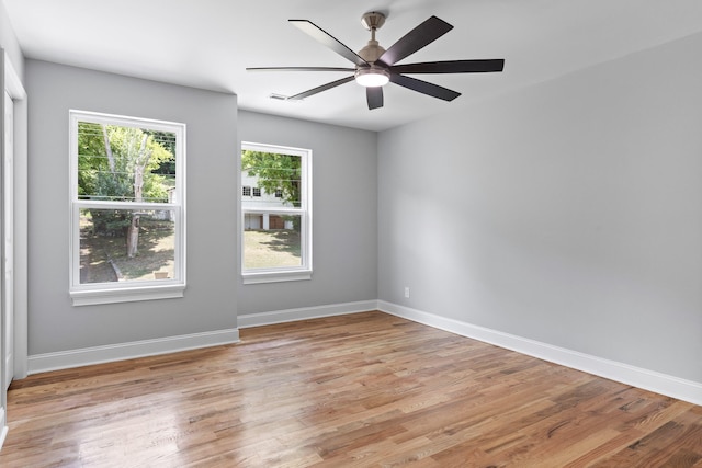 empty room with ceiling fan and light hardwood / wood-style floors