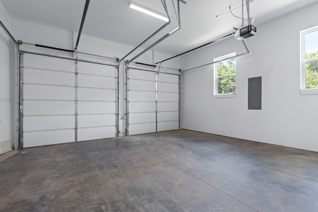 garage with electric panel and a garage door opener