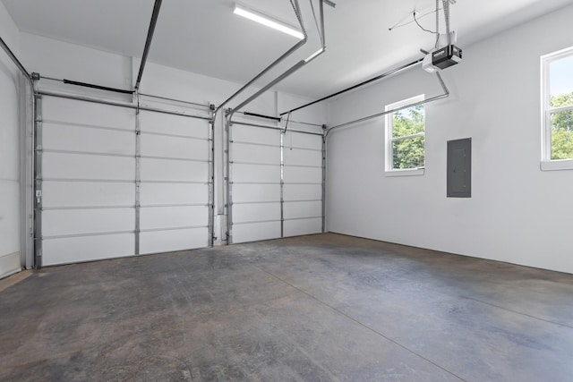 garage featuring electric panel and a garage door opener