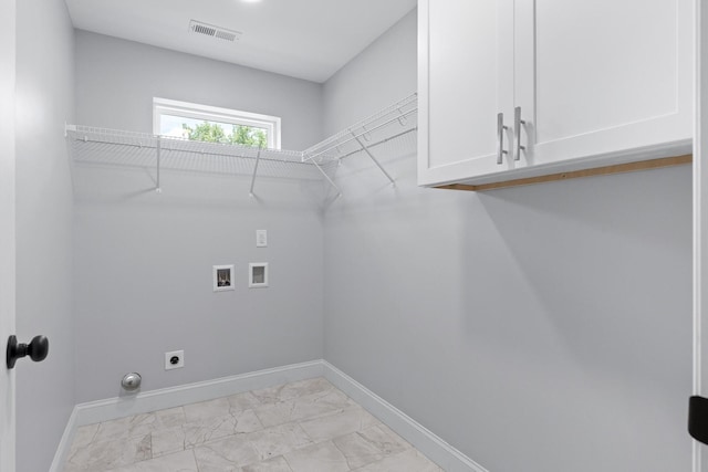 clothes washing area featuring hookup for a washing machine, cabinets, and hookup for an electric dryer