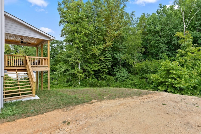 view of yard featuring ceiling fan and a wooden deck