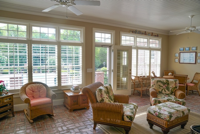 living room with ceiling fan and crown molding