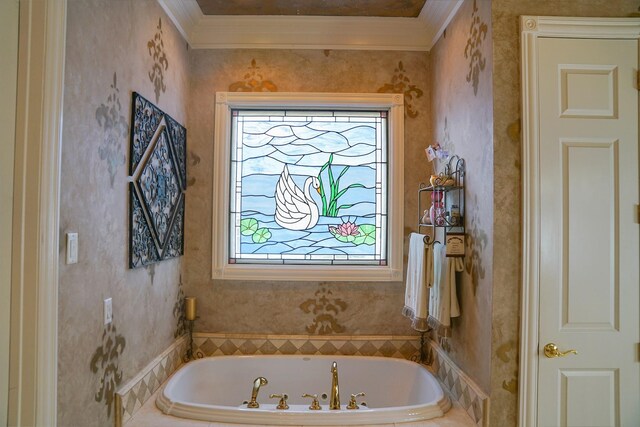 bathroom with ornamental molding, a tub to relax in, and a healthy amount of sunlight