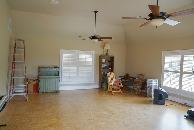 misc room featuring lofted ceiling, light tile patterned floors, and ceiling fan