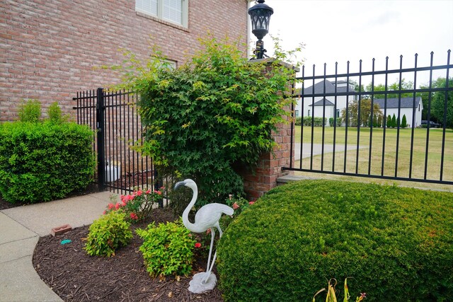 view of gate featuring a lawn