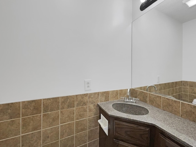 bathroom featuring tile walls and vanity