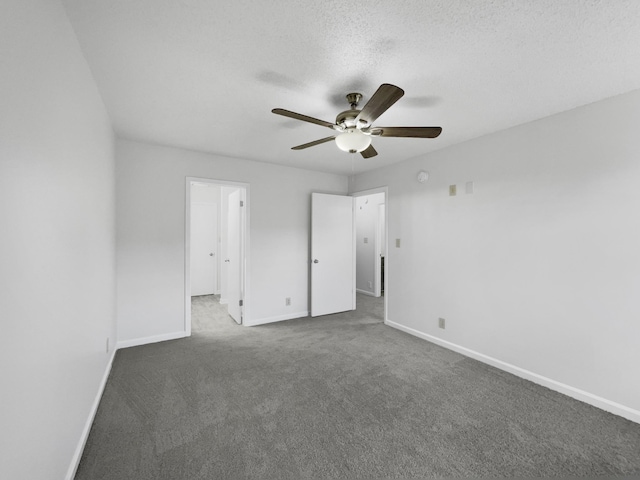 carpeted empty room featuring ceiling fan and a textured ceiling