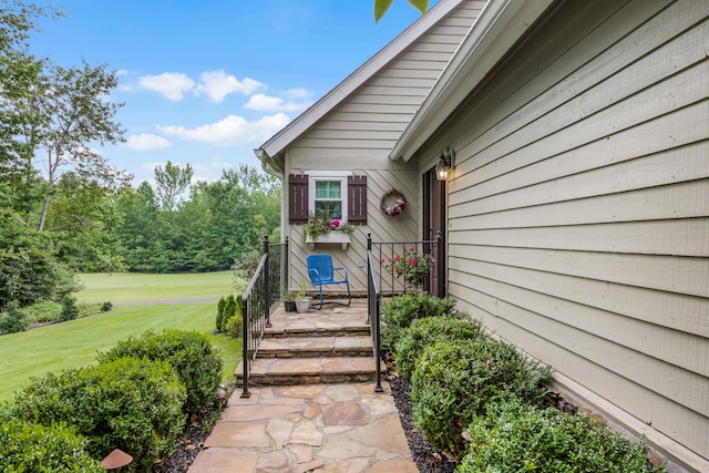 entrance to property with a lawn