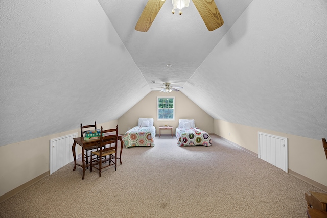 interior space with a textured ceiling, carpet floors, lofted ceiling, and ceiling fan