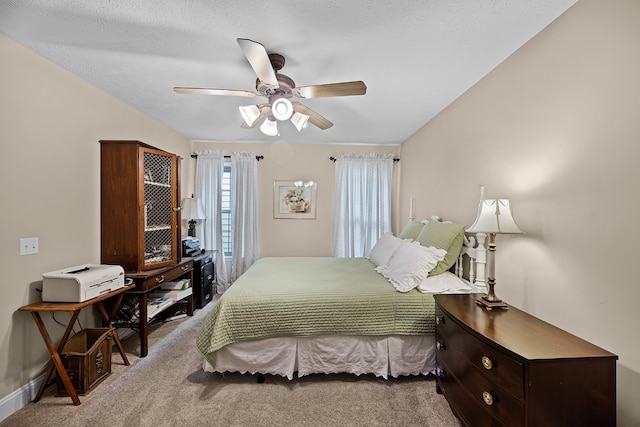 bedroom with carpet, ceiling fan, and a textured ceiling