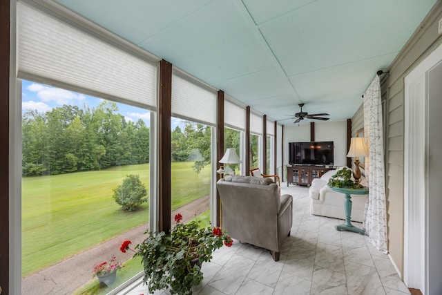 sunroom / solarium with a wealth of natural light and ceiling fan