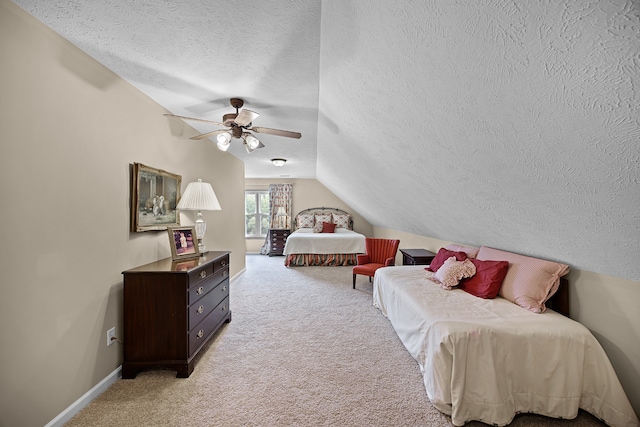 bedroom featuring lofted ceiling, a textured ceiling, light colored carpet, and ceiling fan