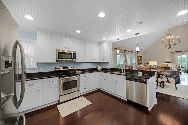 40 Vantage Pt, Counce, TN 38326 - kitchen with appliances with stainless steel finishes, a peninsula, dark countertops, a chandelier, and a sink