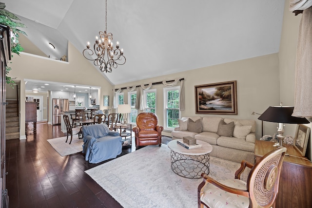 living room with high vaulted ceiling, an inviting chandelier, and dark hardwood / wood-style floors