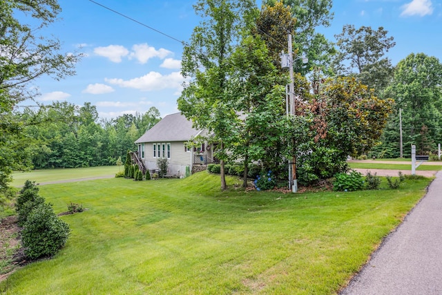 40 Vantage Pt, Counce, TN 38326 - view of home's exterior with a yard and roof with shingles