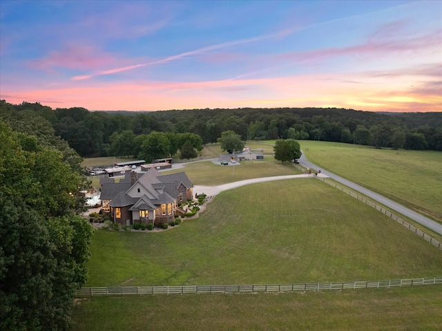 aerial view at dusk featuring a rural view