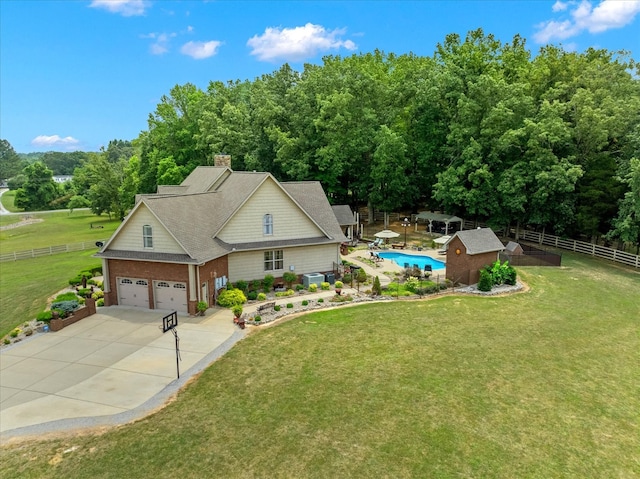 view of front of property featuring a garage and a front lawn