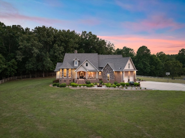 view of front of house featuring a garage and a lawn