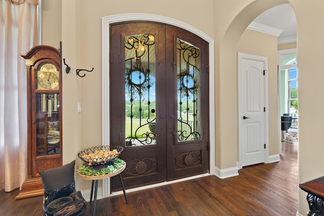 entrance foyer with dark wood-type flooring, french doors, and crown molding